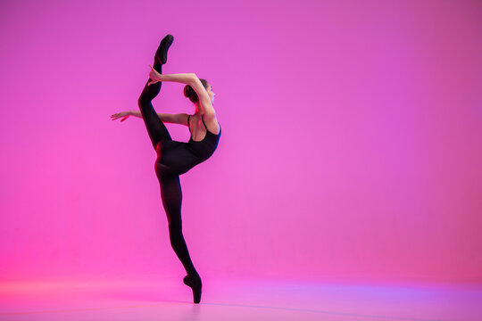 silhouette of a ballet dancer in a black leotard, in graceful motion.