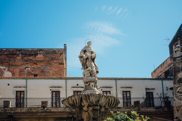 Fototapeta premium Historic fountain statue in courtyard of I Segreti del Chiostro
