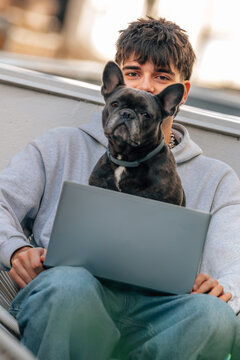 studente with dog an laptop