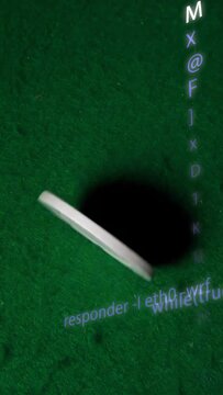 Vertical video: White disc spinning across green felt offcam push hiding projected code tech demo