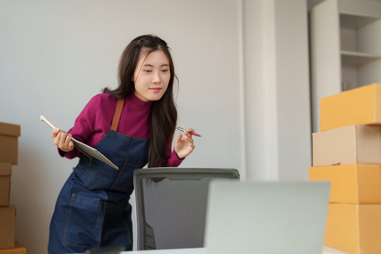 Young woman managing online small business orders