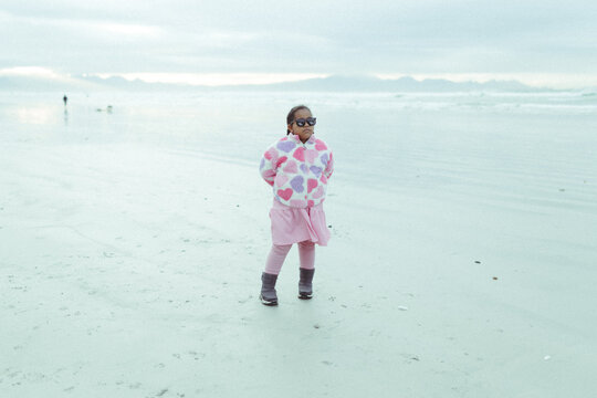 Young mixed race girl on the beach in winter