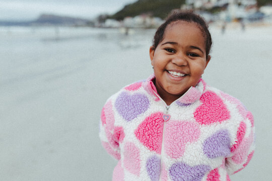 Young mixed race girl on the beach in winter