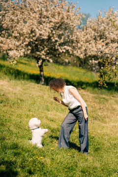 Woman and dog enjoy time together during spring sunny day