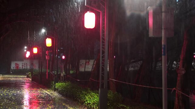 Rainy Night Street with Red Lanterns Illuminating Wet Pavement in Urban China