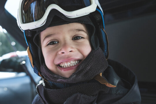 Close up of a smiling boy in a ski helmet