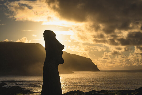 Silhouette of a moai statue at sunset on Easter Island