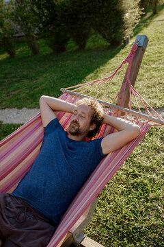 Man resting on a hammock at ecological campsite