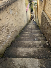 Fototapeta premium Man stands at top of steep concrete stairs