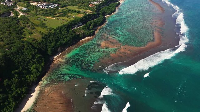 Spectacular drone panorama over Green Bowl Beach reef &ndash; Hidden tropical paradise with crystal clear waves, white sand, and lush limestone cliffs in Bali &ndash; High angle nautical landscape