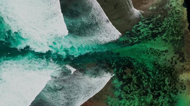 Spectacular drone panorama over Green Bowl Beach reef &ndash; Hidden tropical paradise with crystal clear waves, white sand, and lush limestone cliffs in Bali &ndash; High angle nautical landscape