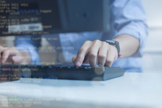 close up computer programmer man hand typing configuration on keyboard at laptop for input coding language to software for fix bug and defect of system in data center room , engineering and technology