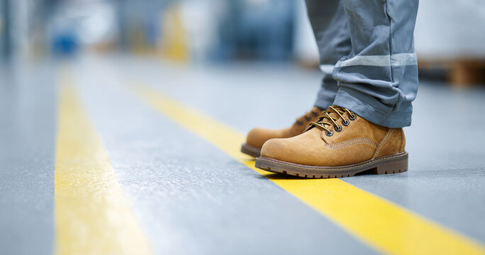 Worker wearing safety boots on factory floor