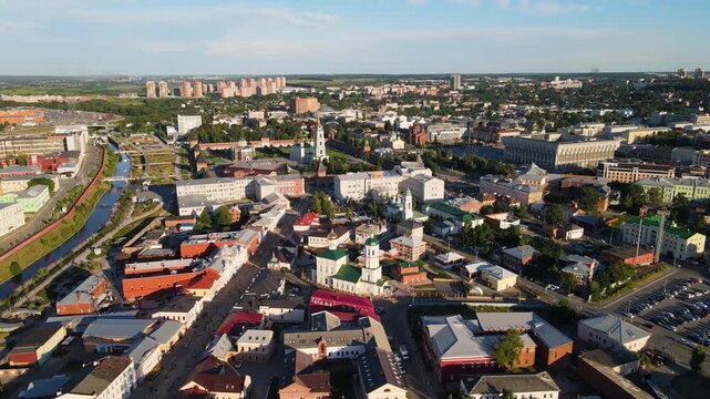 Wide aerial panorama of the historical center of Tula, Russia. Features the Kremlin fortress, ancient cathedrals with golden domes, and city architecture along the Upa river on a clear sunny day