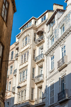A vintage building with windows and small bay windows.