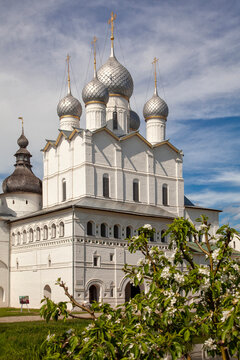 White stone church with silver domes under blue sky
