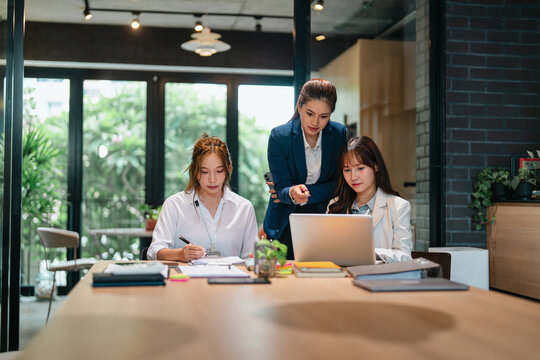 Female leader guiding new staff member at office with career advice and skill development discussion