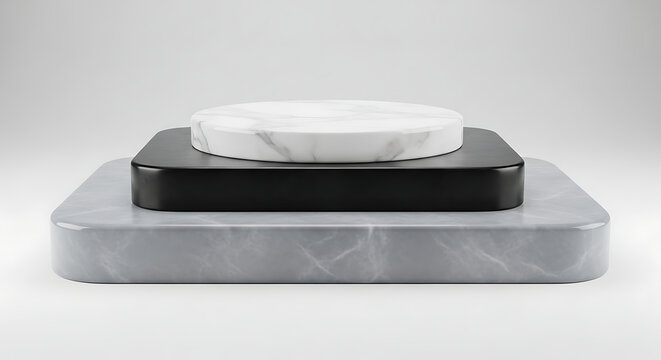 A three-tiered display podium with a rounded square grey marble base a black square middle tier and a white marble circular on a light grey