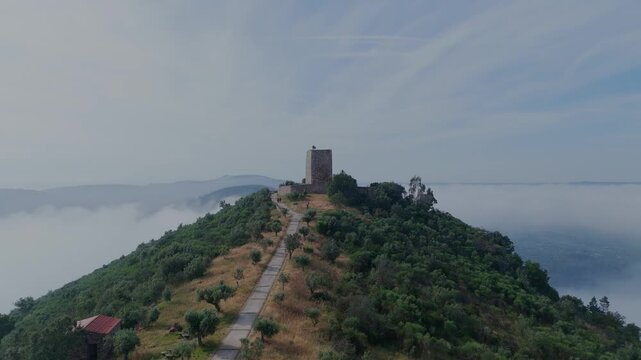 Horizontal drone shot rising over Portas do Rodao Natural Monument near Castelo Branco Portugal revealing the tower of Castelo de Rodao in the background.