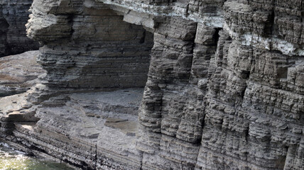 Fototapeta premium Ancient Layered Geological Formations: Prehistoric Landscape Reflecting Earth's Primeval Era and Potential for Dinosaur Footprints