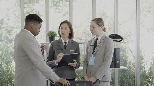 The manager is training airline staff on how to work on an airplane.