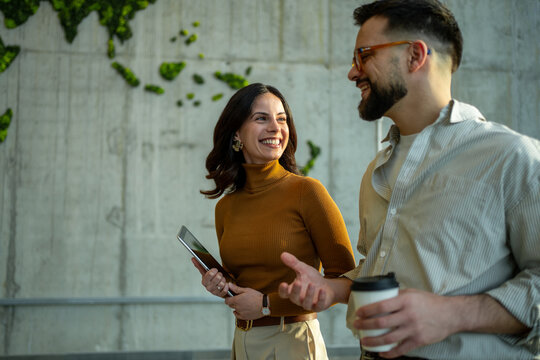 Business colleagues collaborating and discussing ideas while walking
