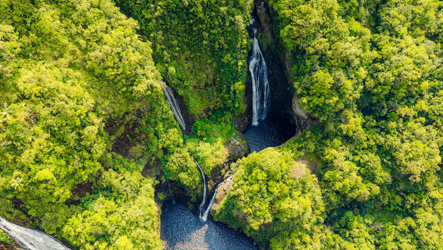 Aerial overhead view of waterfalls in green tropical canyon