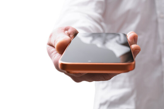 Close-up of a professional in white shirt holding a modern orange smartphone with blank black screen against. Concept of mobile communication, business technology, apps and digital connection.
