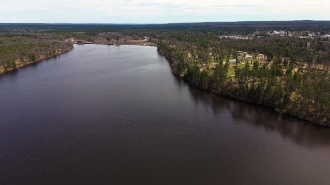 Drone flying to the back of Mio Dam and the start of Mio Pond impoundment on the AuSable River in Michigan