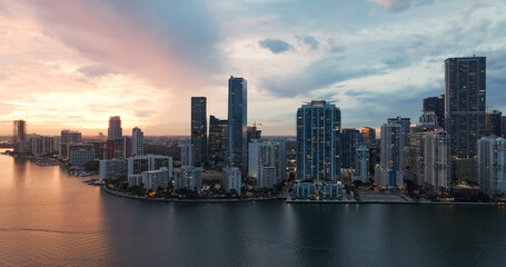 Fototapeta premium Miami downtown skyline illuminating biscayne bay at sunset