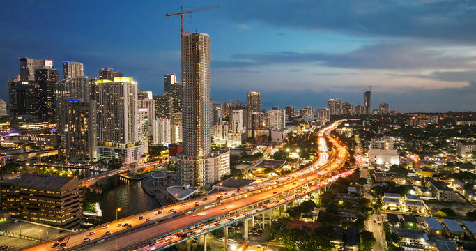 Miami cityscape with illuminated highway traffic during dusk
