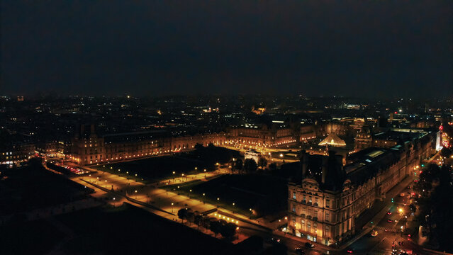 Louvre museum and tuileries garden at night, aerial view paris