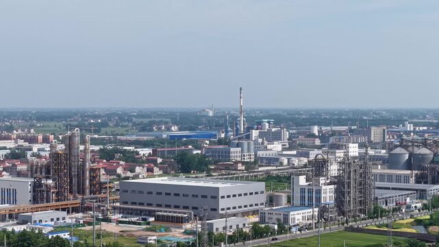 aerial view of an industrial zone with a large power plant complex and cooling towers