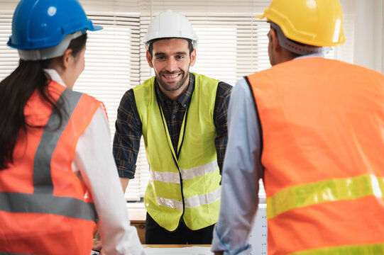Multi ethnicity group of engineers, architects and construction worker or business people working and discussing about building project in modern office, Architecture and Engineering concept