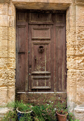 Fototapeta premium Old wooden door in stone frame in southern France