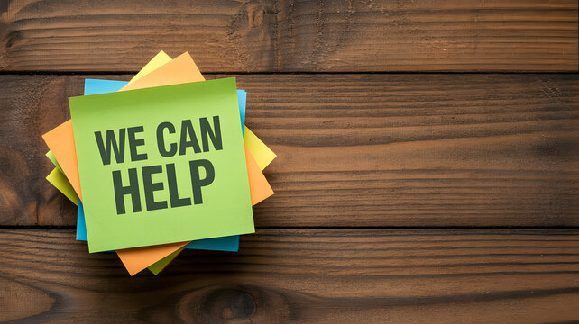 A stack of colorful sticky notes with a message on a wooden background