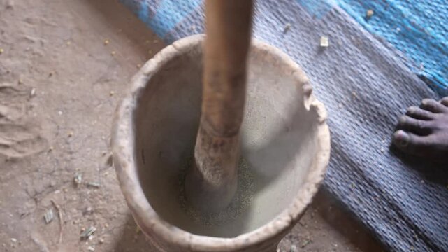 Close up of pounding dried vegetables in mortar for traditional food, April 25, 2026, Chad, N Djamena