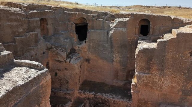 Cinematic Forward Push Toward Rock-Cut Cave Entrance in Dara