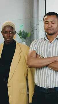 Creative diverse male business people, office workers team standing in row looking at camera. Insurance, marketing and financial consulting concept. Slow motion
