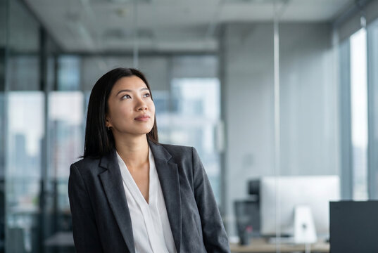 Asian businesswoman looking up, seeing her future goals and opportunities