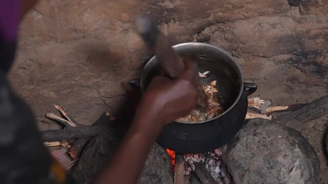 Close up of traditional African food cooking over open fire, April 25, 2026, Chad, N Djamena