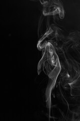 Fototapeta premium White hot curly steam smoke isolated on black background. Abstract background, design element, for overlay on pictures. Create mystical photos