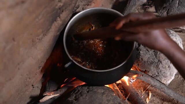 Close up of traditional African food cooking over open fire, April 25, 2026, Chad, N Djamena