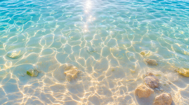 Water ripple texture turquoise clear sunlight reflection rock gentle wave shallow sea surface with soft caustic pattern over sand and stone creating calm summer background with serene mood