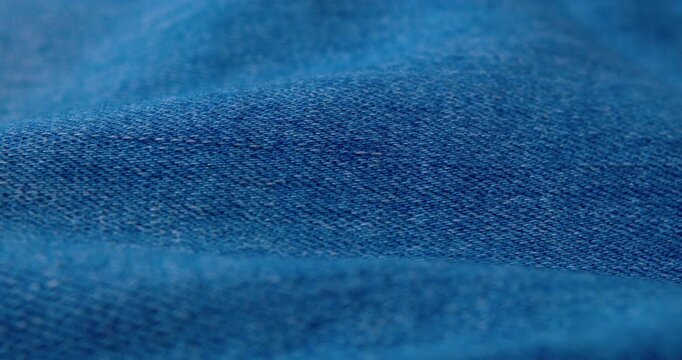 Close-up video of wrinkled denim fabric.abstract background.