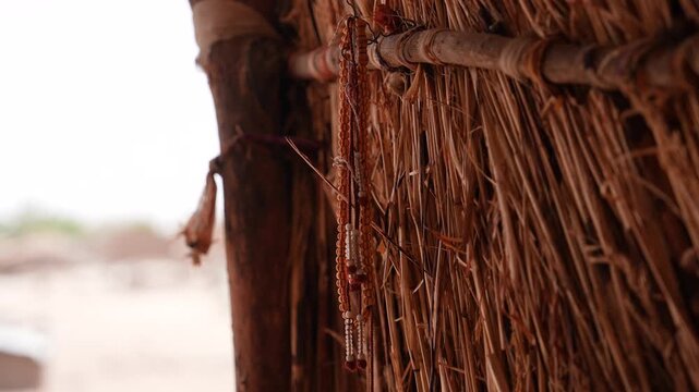 Close up of prayer beads hanging in corner of village house, April 25, 2026, Chad, N Djamena