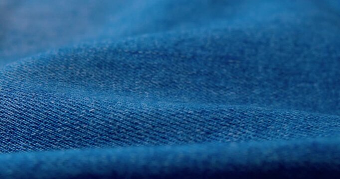 Close-up video of wrinkled denim fabric.abstract background.
