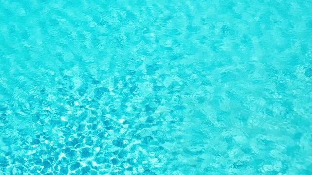 blue water waves on surface of swimming pool, slow motion 
