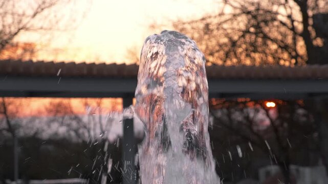 fountain jet at sunset, close-up, slow motion
