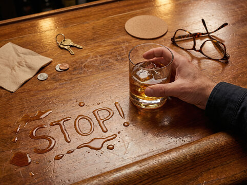 A bar scene with whiskey, everyday items, and a STOP message supports alcohol awareness themes. Works for moderation, informed choices, and responsible drinking communication